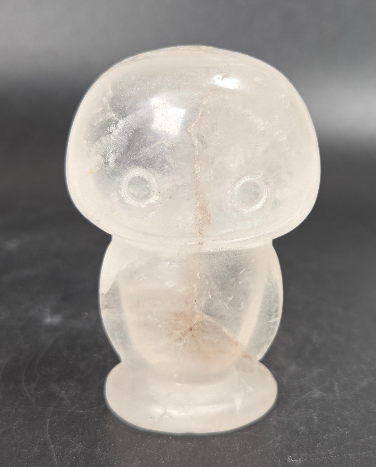 Eva form carving, made of clear Quartz, displayed on a black background.