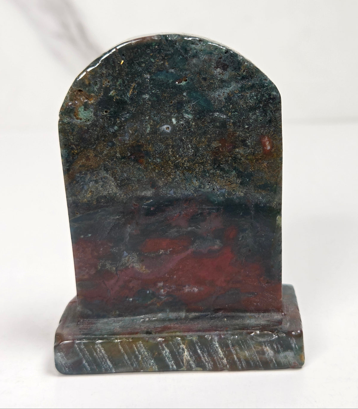 Ocean Jasper tombstone carving with against a white background