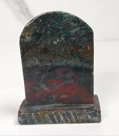 Ocean Jasper tombstone carving with against a white background