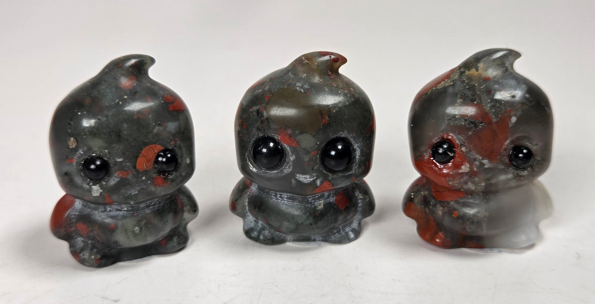 stylized carvings made of a black and red crystal on a white background