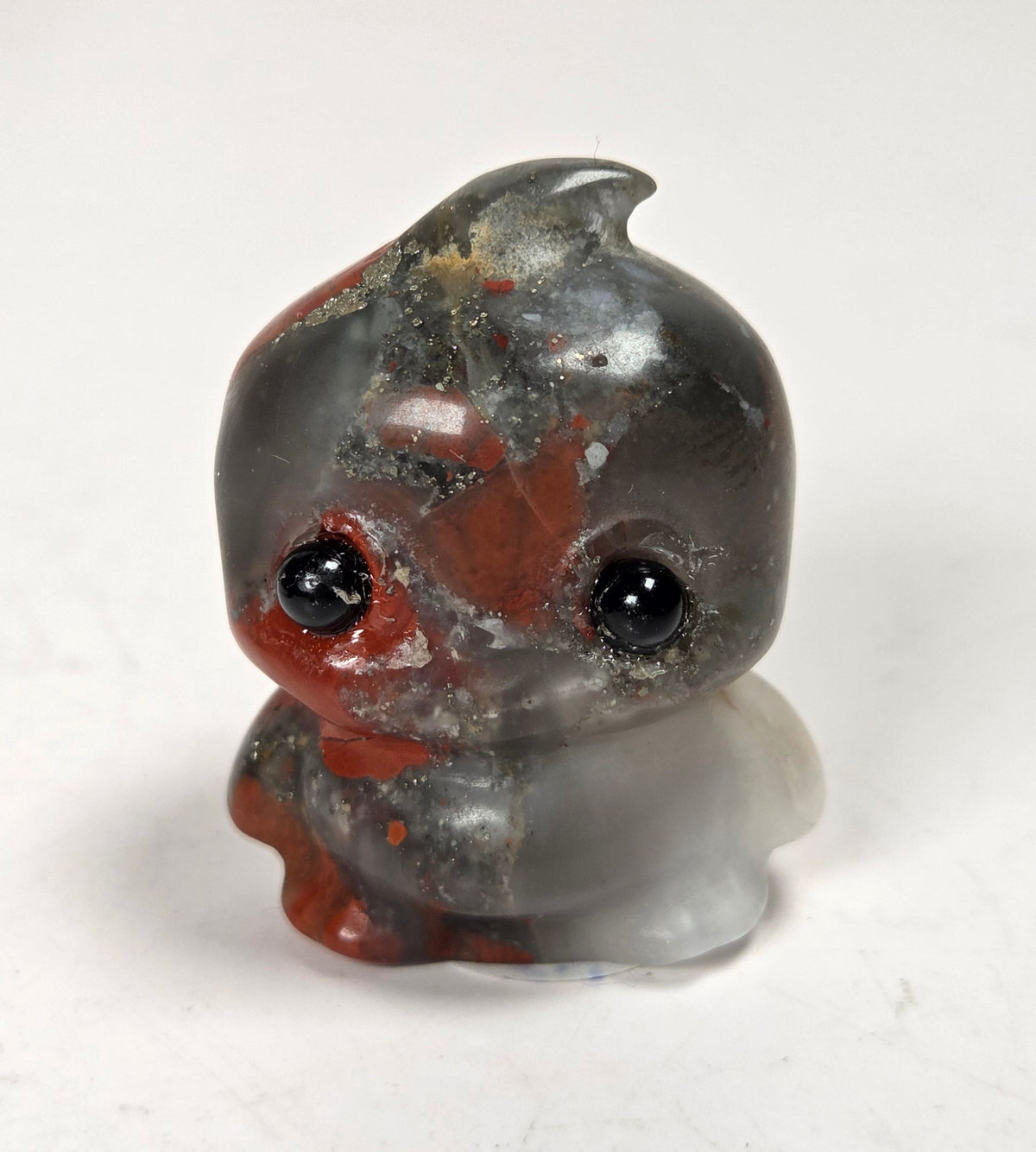 stylized carving made of a black and red crystal on a white background