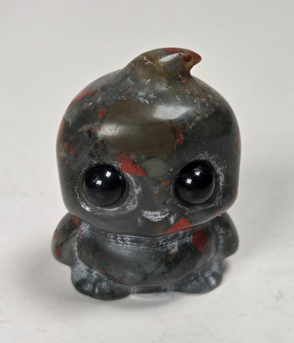 stylized carving made of a black and red crystal on a white background
