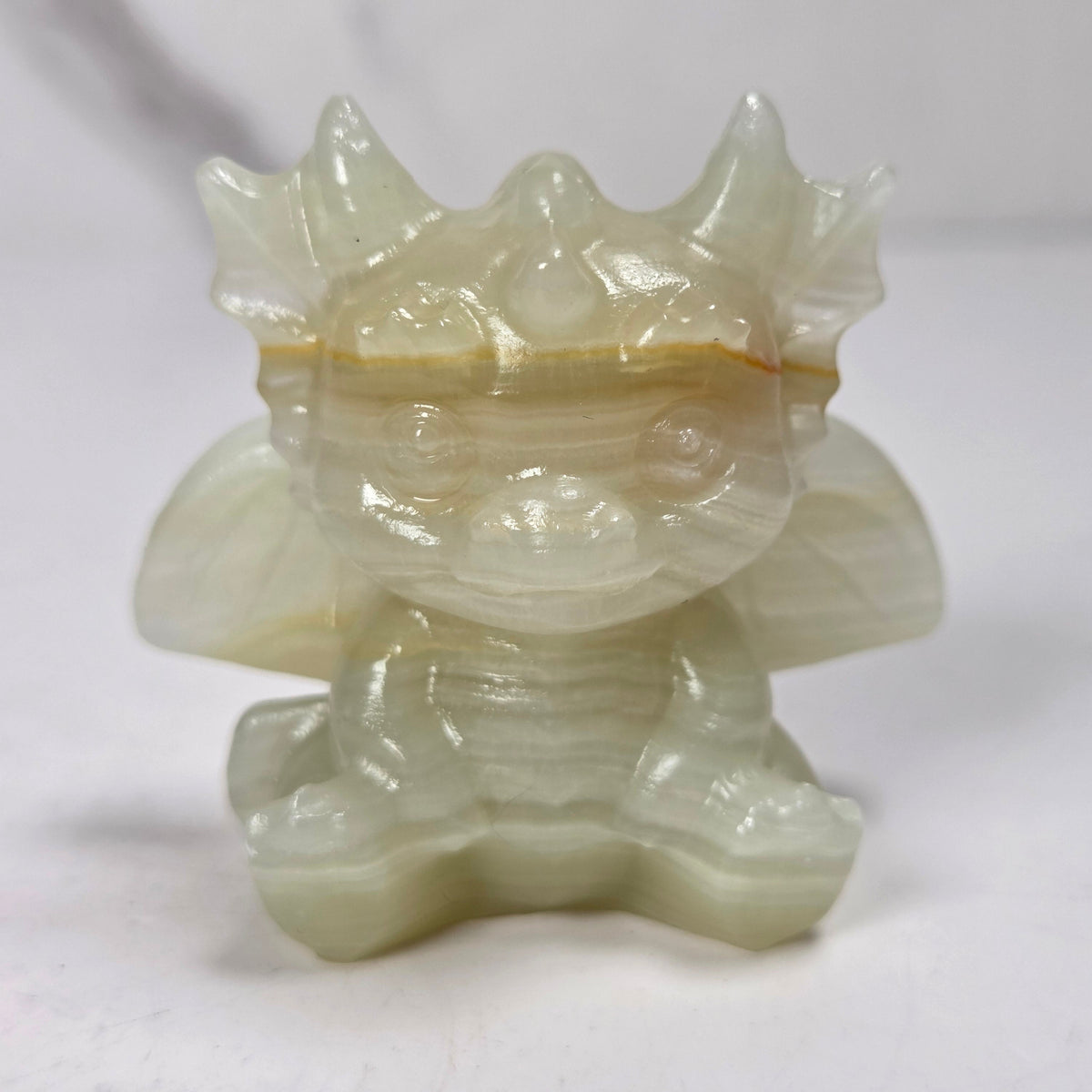 A small crystal dragon figurine against a dark background.