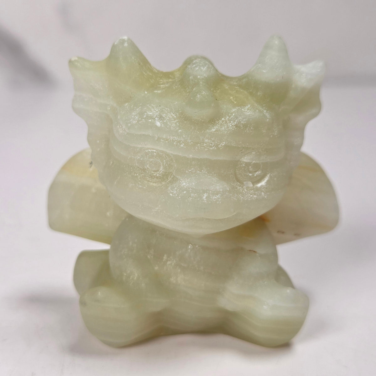A small crystal dragon figurine against a white background.