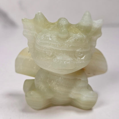 A small crystal dragon figurine against a white background.