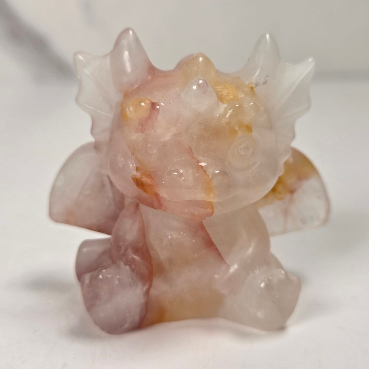 A small crystal dragon figurine against a white background.