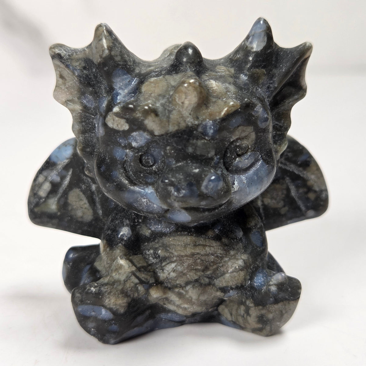A small crystal dragon figurine against a white background.