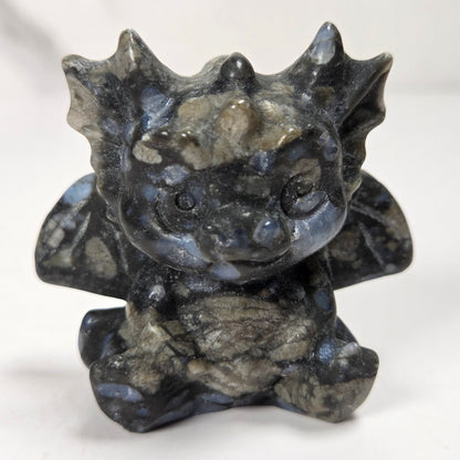 A small crystal dragon figurine against a white background.
