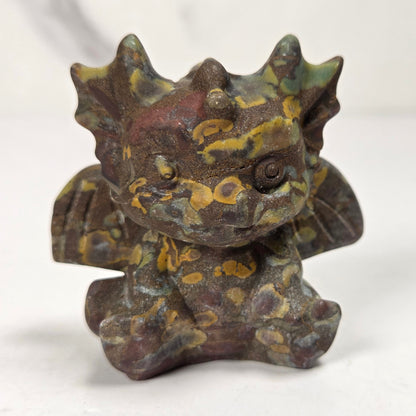 A small crystal dragon figurine against a white background.