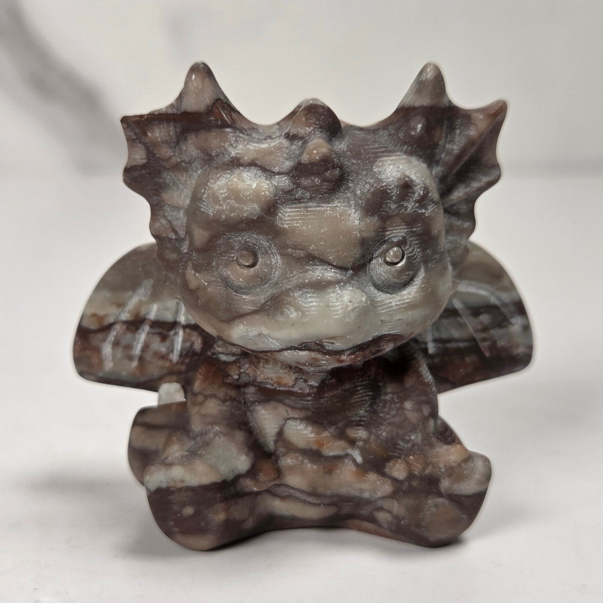 A small crystal dragon figurine against a white background.
