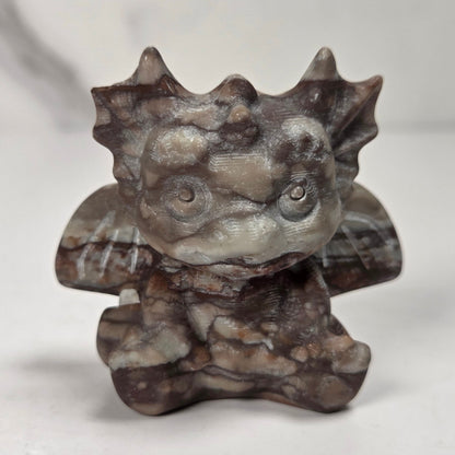 A small crystal dragon figurine against a white background.