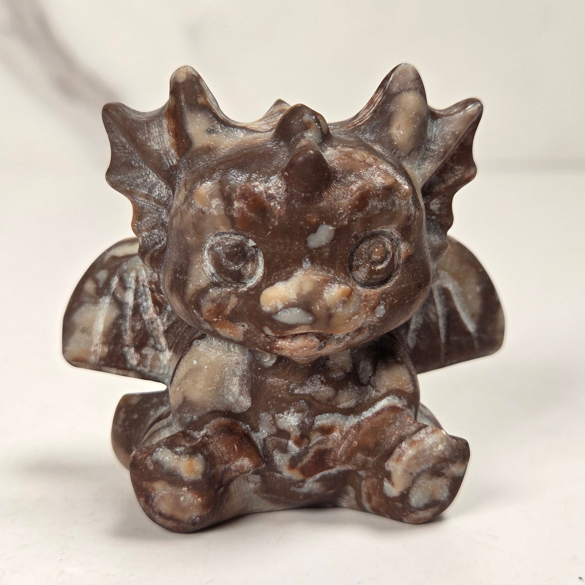 A small crystal dragon figurine against a white background.