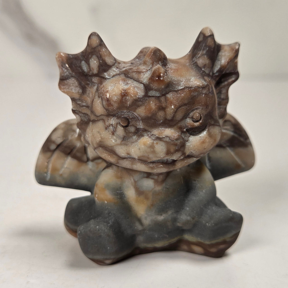 A small crystal dragon figurine against a white background.