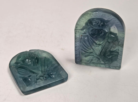 Fluorite carvings of a Yoda like character against a white background