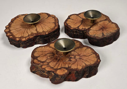 Wood slabs with bronze sphere holders against a white background