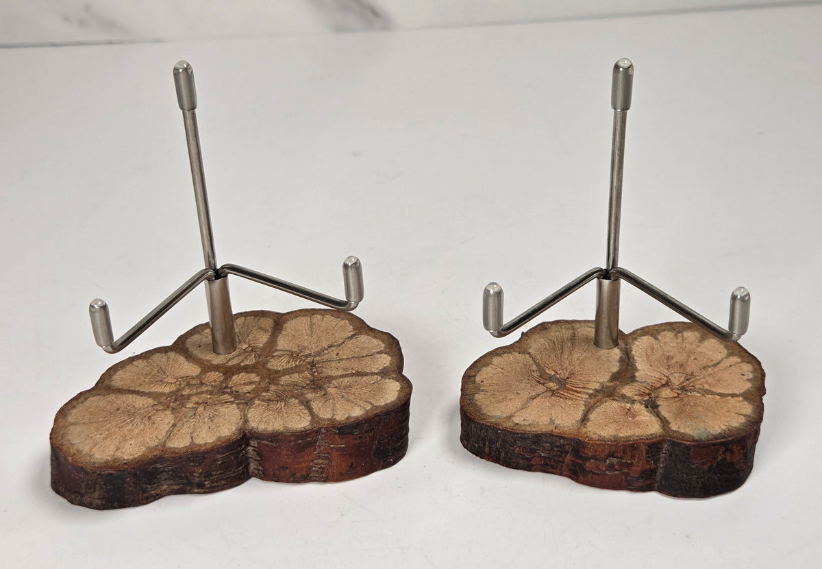 Wood slabs with metal brackets against a white background