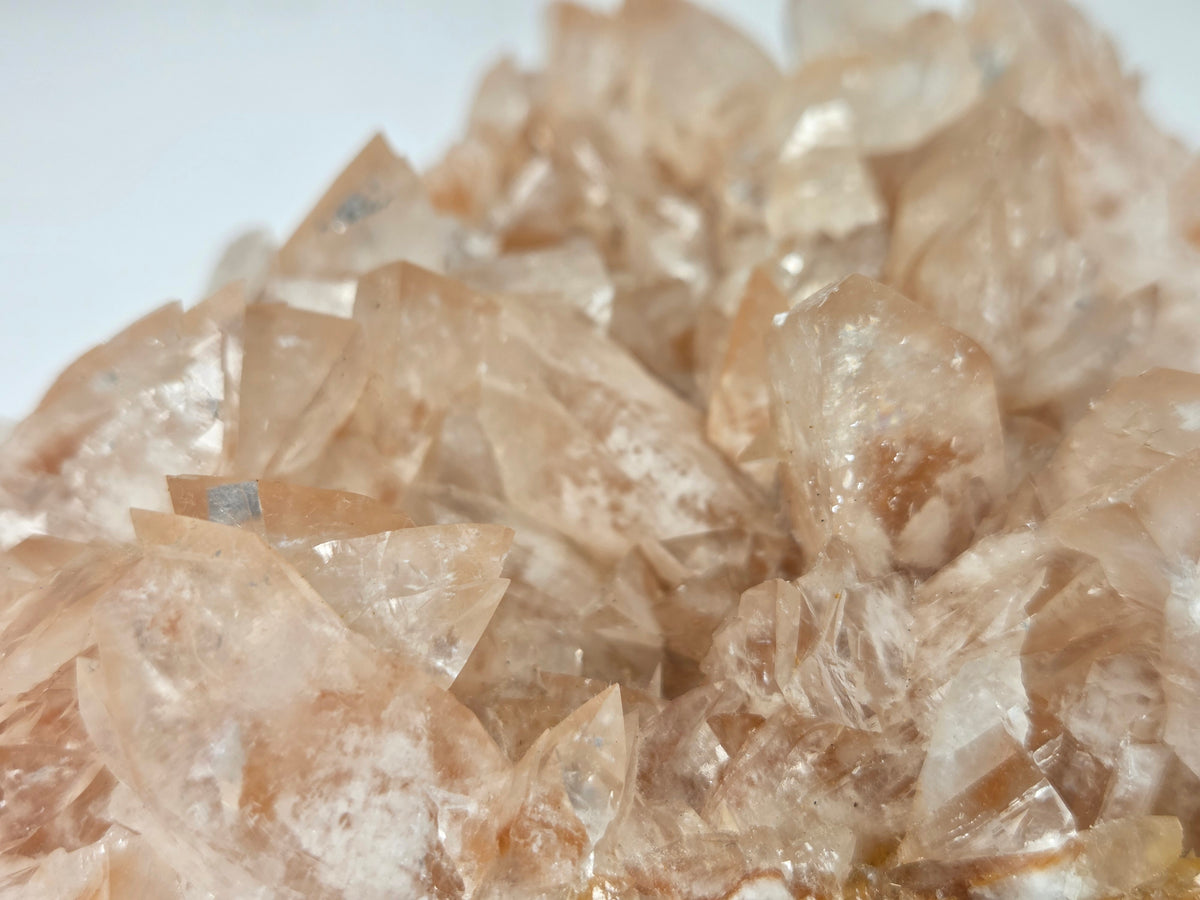 Close-up of a pink colored calcite specimen against a marbled background