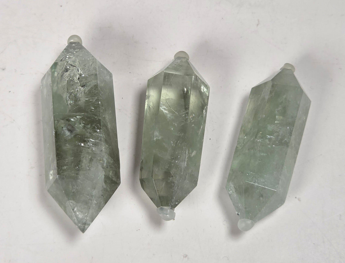 green quartz carved points against a white background