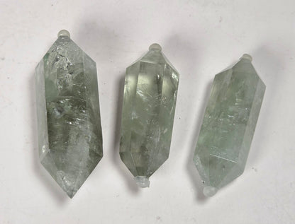 green quartz carved points against a white background