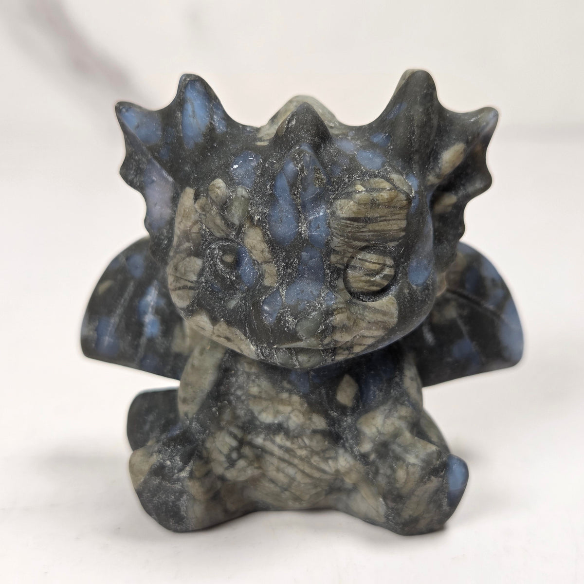A small crystal dragon figurine against a white background.