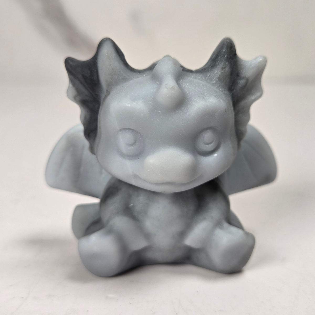 A small crystal dragon figurine against a white background.