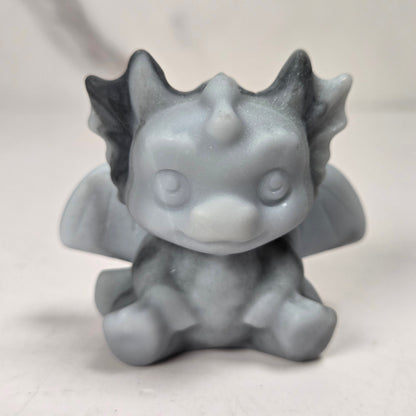 A small crystal dragon figurine against a white background.
