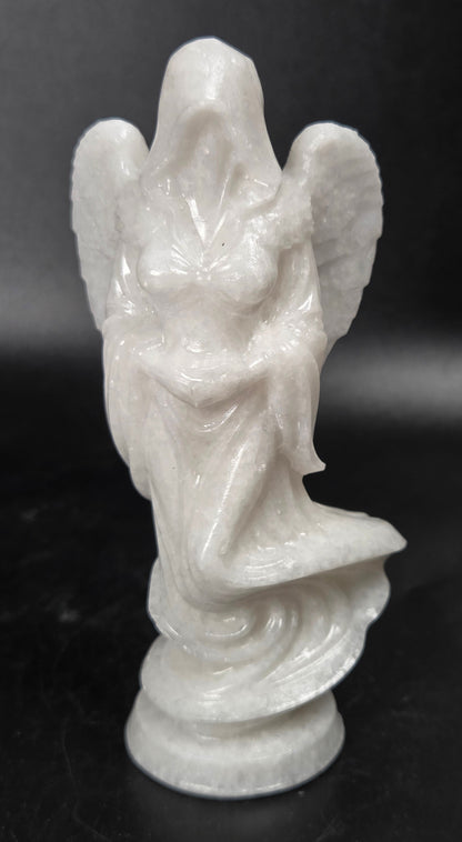 White Jade crystal carving of a woman wearing a robe and angel wings against a white background