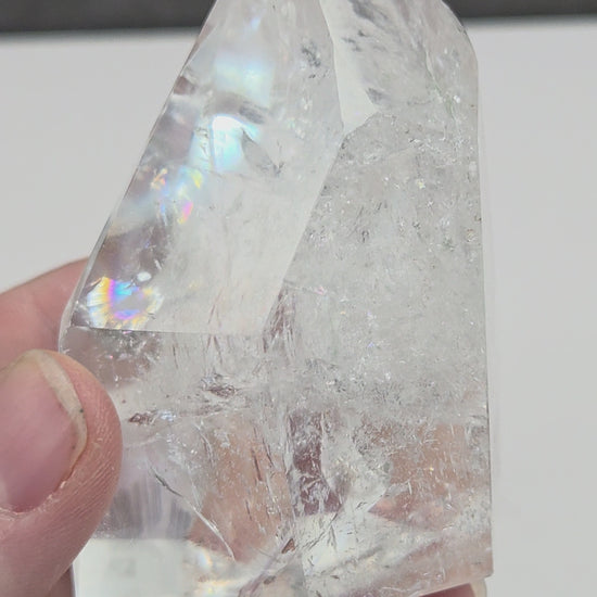 Clear Quartz tower crystal on a dark gray background
