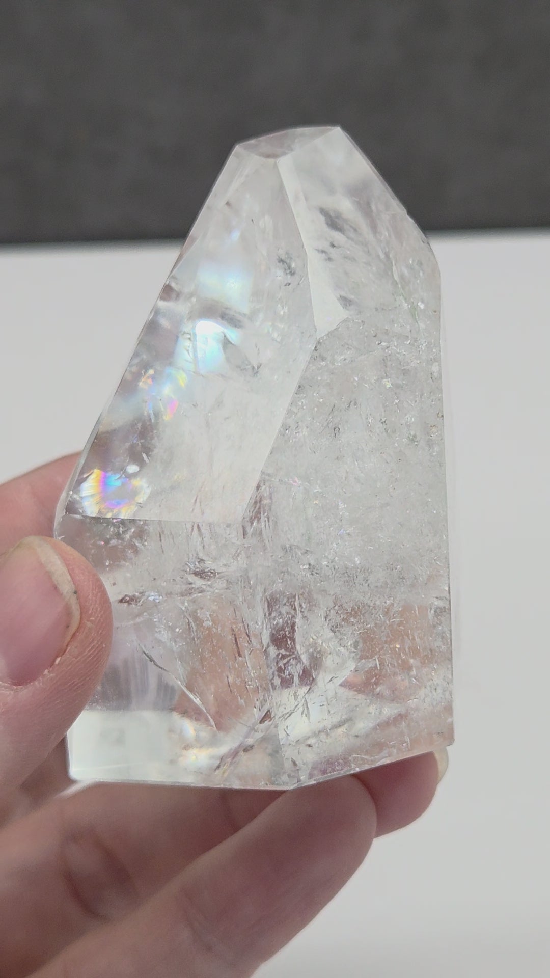 Clear Quartz tower crystal on a dark gray background